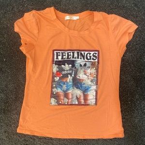 Orange tee, adidas logo with random fashion design. Super cute.